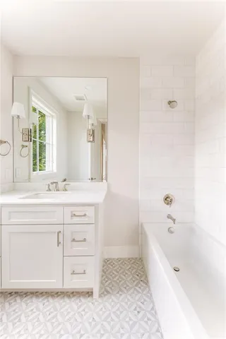 a bathroom with a granite countertop sink a toilet and bathtub