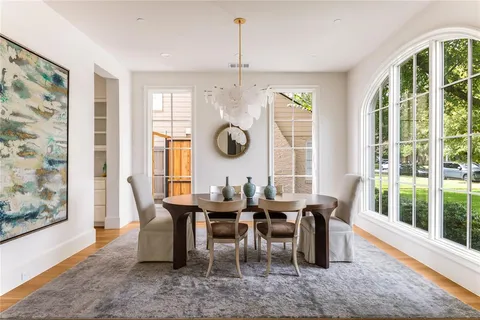 a view of a dining room with furniture large windows and wooden floor