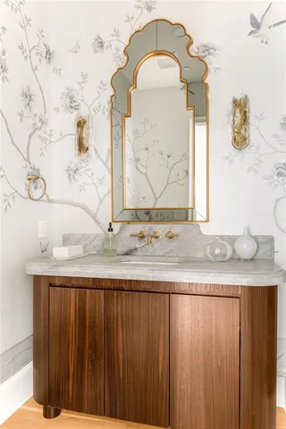 a bathroom with a granite countertop sink and a mirror