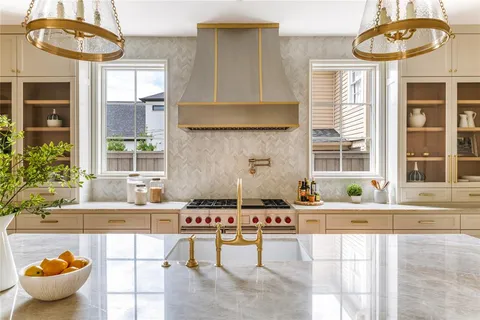 a kitchen with a stove a sink and a table