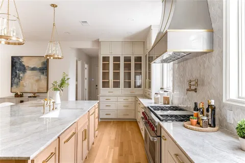 a kitchen with sink stove and cabinets