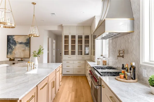 a kitchen with sink stove and cabinets