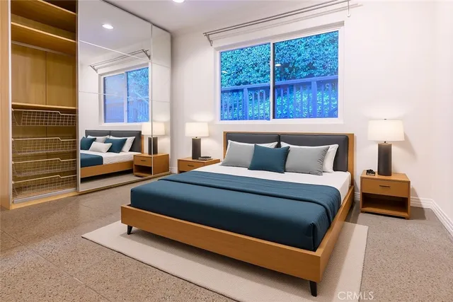 a bedroom with a bed and a window