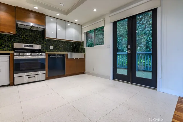 a open kitchen with stainless steel appliances granite countertop a stove top oven a sink and a refrigerator