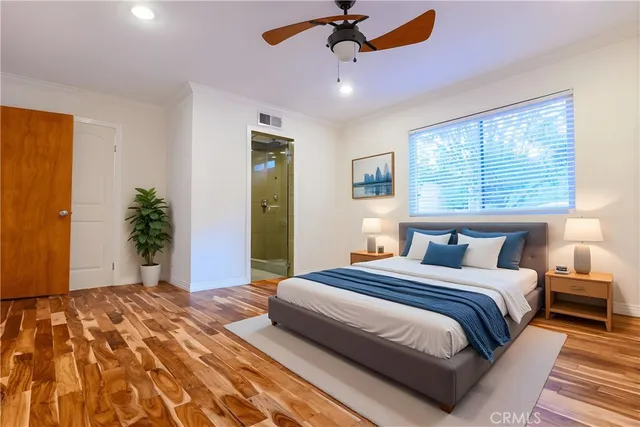 a bedroom with a large bed and a chandelier