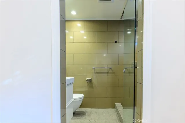 a bathroom with a toilet and a shower