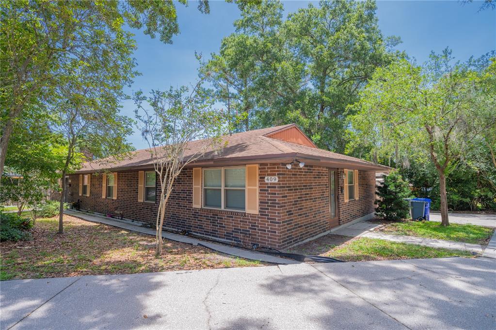411 High View Lane Lakeland, FL 33803 - Photo 1 of 1 a front view of a house with a yard and garage