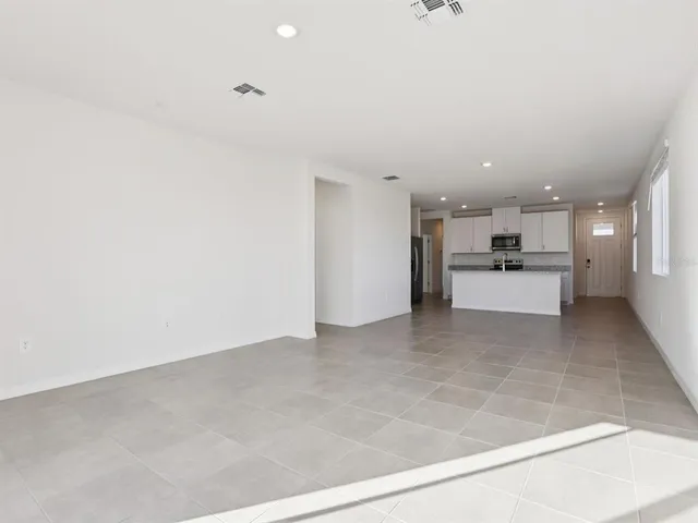 a kitchen with appliances a sink and cabinets