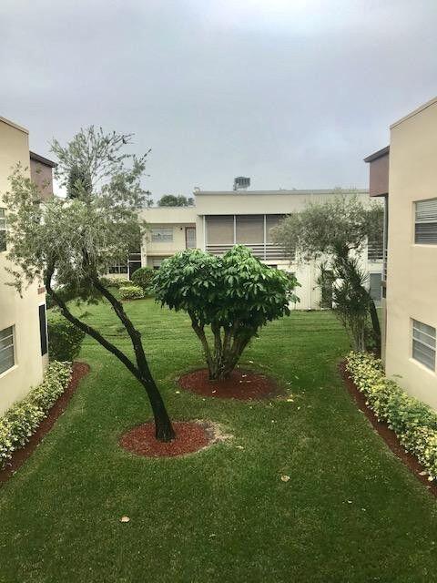729 Normandy P Delray Beach Delray Beach, FL 33484 - Photo 1 of 6 a view of a house with a backyard and a patio