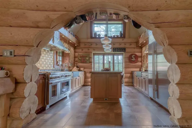 a living room with furniture a fireplace and a chandelier