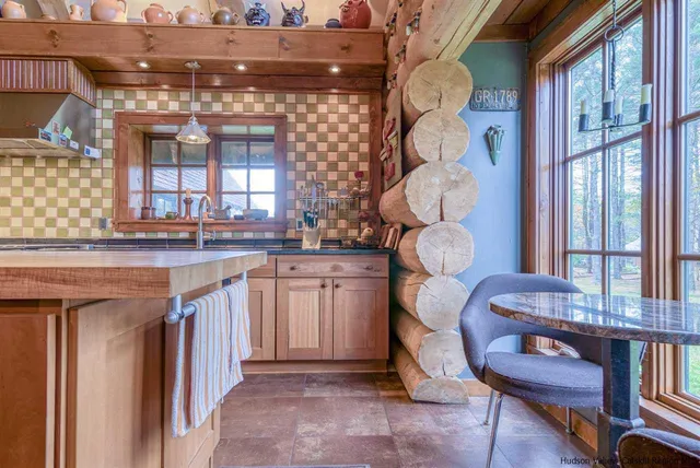 a kitchen with cabinets and window