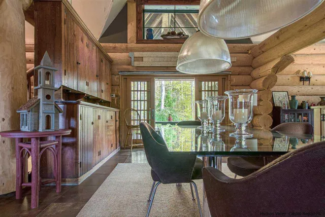 a room with lots of wooden furniture and a chandelier