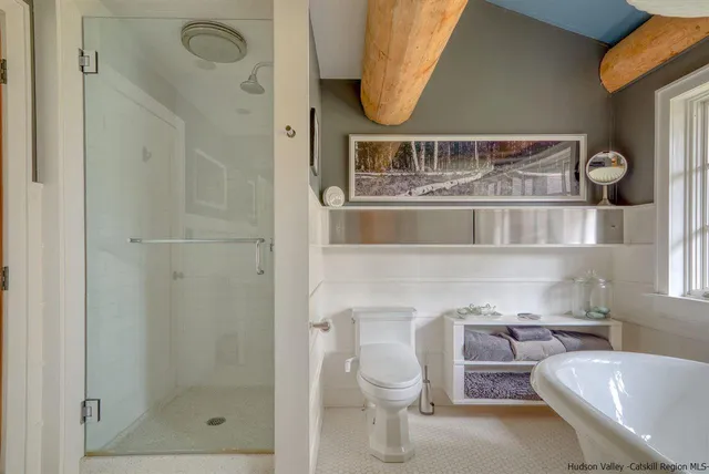 a bathroom with a toilet sink and window