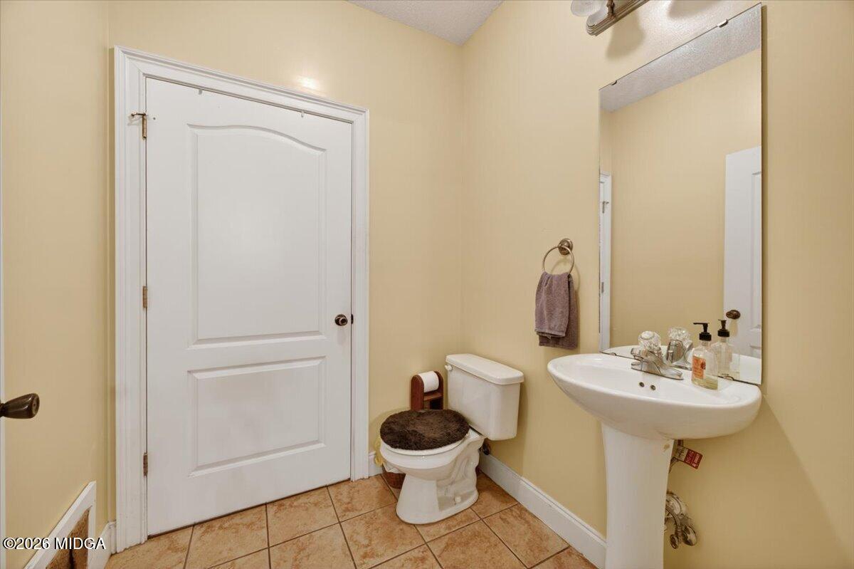 619 Grayridge Road Gray, GA 31032 - Photo 30 of 40 a bathroom with a sink a toilet and a mirror