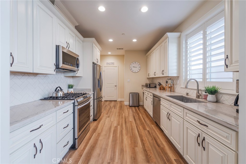 14944 Texaco Avenue Paramount, CA 90723 - Photo 6 of 25 Bright galley kitchen with expansive countertops and abundant cabinetry.