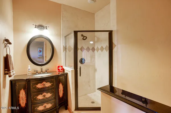 a bathroom with a sink a mirror and a shower