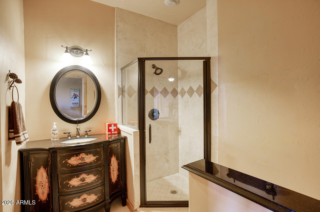 13090 Ghost Train Trail Parks, AZ 86046 - Photo 15 of 23 a bathroom with a sink a mirror and a shower
