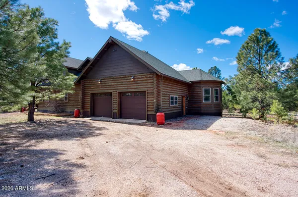 a view of a house with a yard and garage