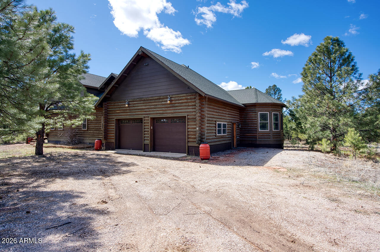 13090 Ghost Train Trail Parks, AZ 86046 - Photo 22 of 23 a view of a house with a yard and garage