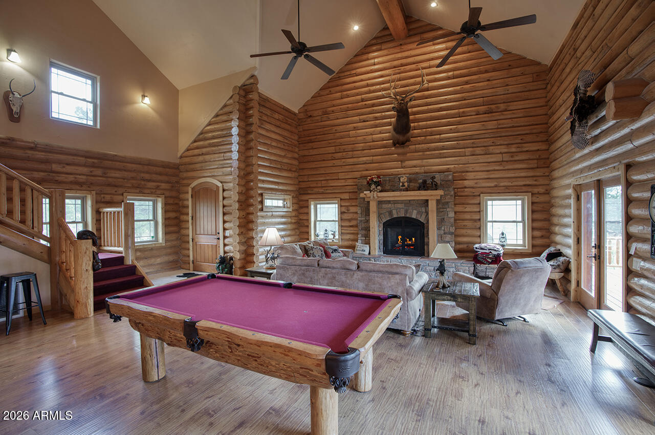 13090 Ghost Train Trail Parks, AZ 86046 - Photo 4 of 23 a living room with furniture pool table wooden floor and a fireplace
