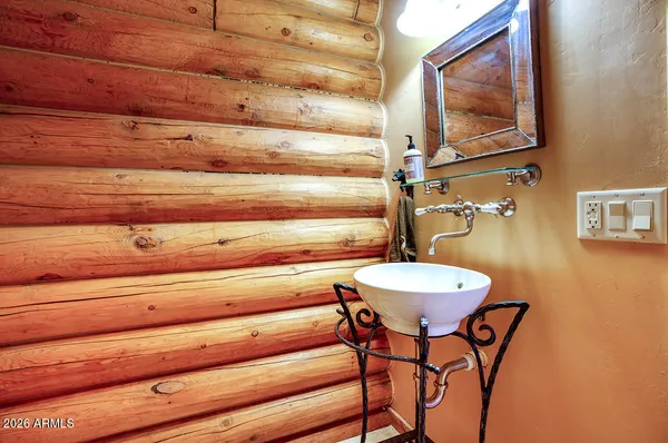 a bathroom with a table and a mirror
