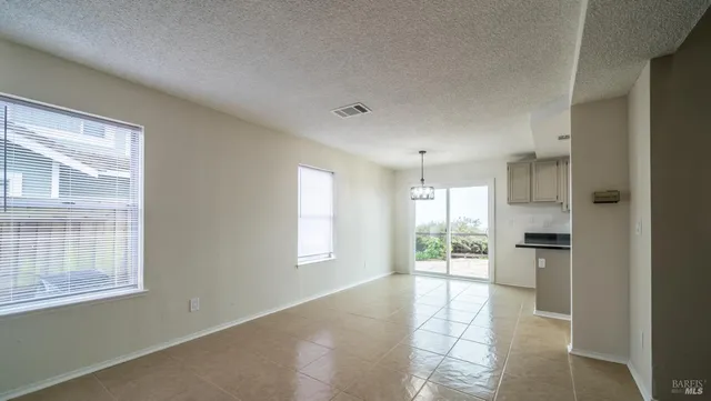 a view of an empty room with a kitchen stove and refrigerator