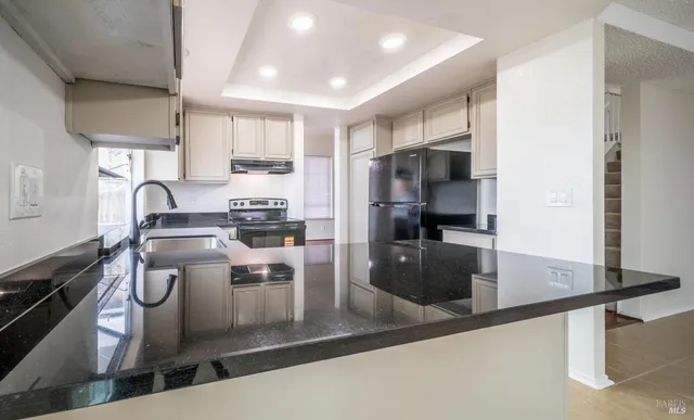 a kitchen with a sink cabinets and stainless steel appliances