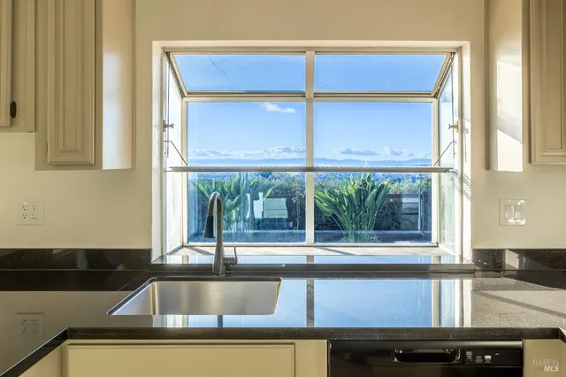 a kitchen with a sink and a large window