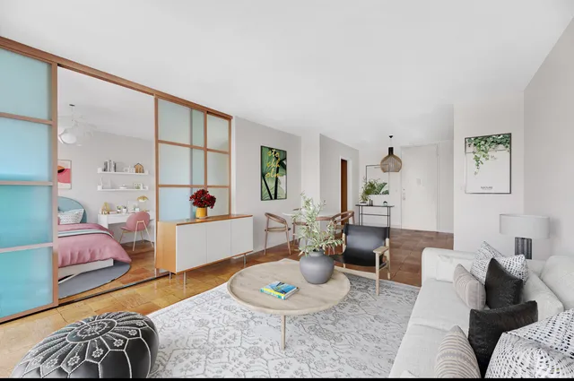 a living room with furniture and a wooden floor