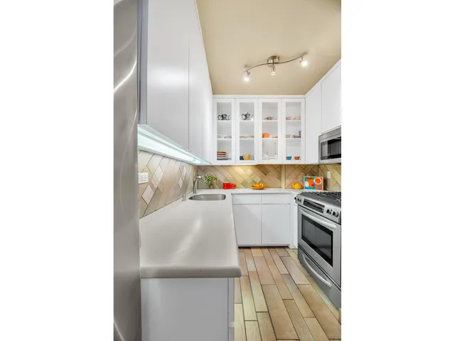 a kitchen with a sink and cabinets