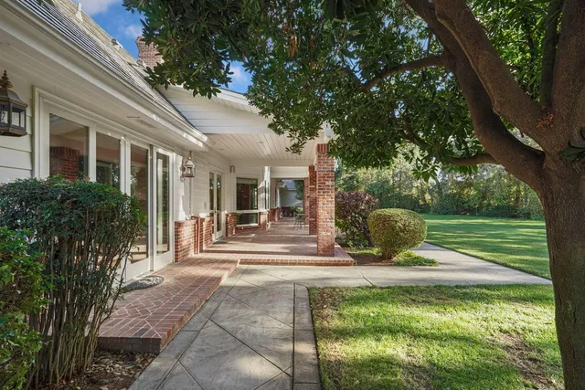 a view of an empty room with a fireplace and a window