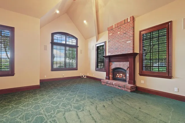 a view of a kitchen with granite countertop a sink and dishwasher a stove with wooden floor