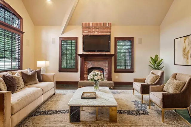 a living room with fireplace furniture and a wooden floor