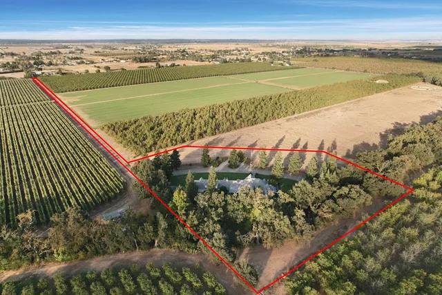 an aerial view of a house with garden space and street view
