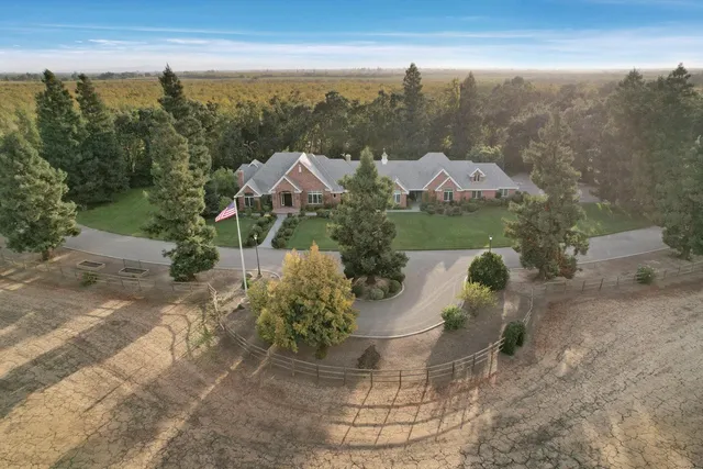 a view of a patio with table and chairs with wooden fence and plants