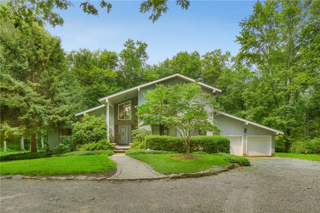 205 Upper Shad Road Pound Ridge, NY 10576 - Photo 1 of 1 a backyard of a house with plants and trees