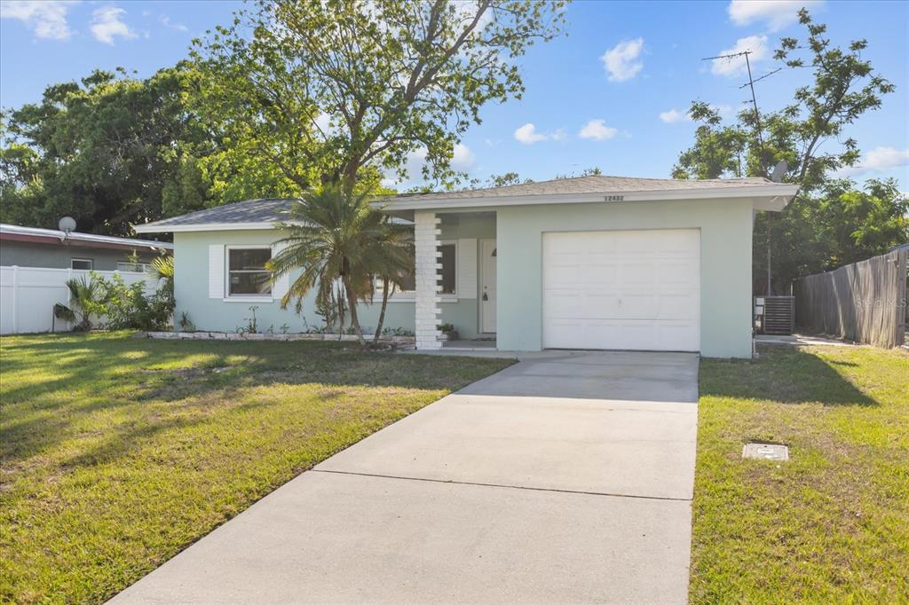 12432 136th Lane Largo, FL 33774 - Photo 1 of 24 a view of house with swimming pool and yard