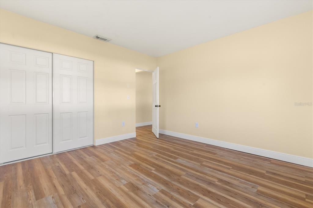 12432 136th Lane Largo, FL 33774 - Photo 11 of 24 a view of an empty room with wooden floor