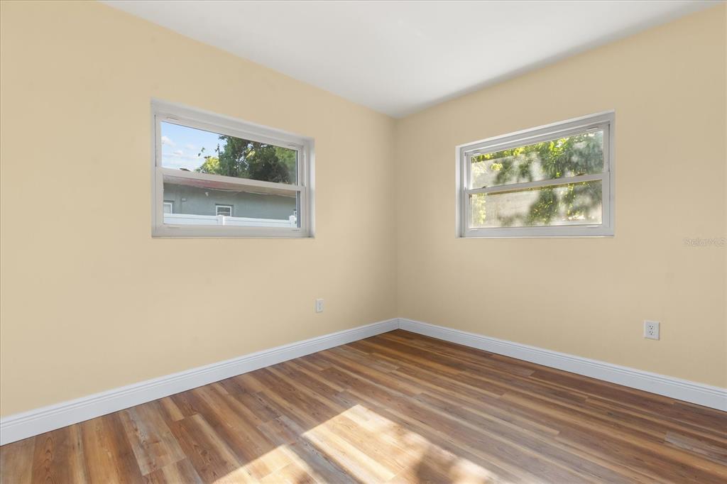 12432 136th Lane Largo, FL 33774 - Photo 14 of 24 a view of an empty room with wooden floor and a window