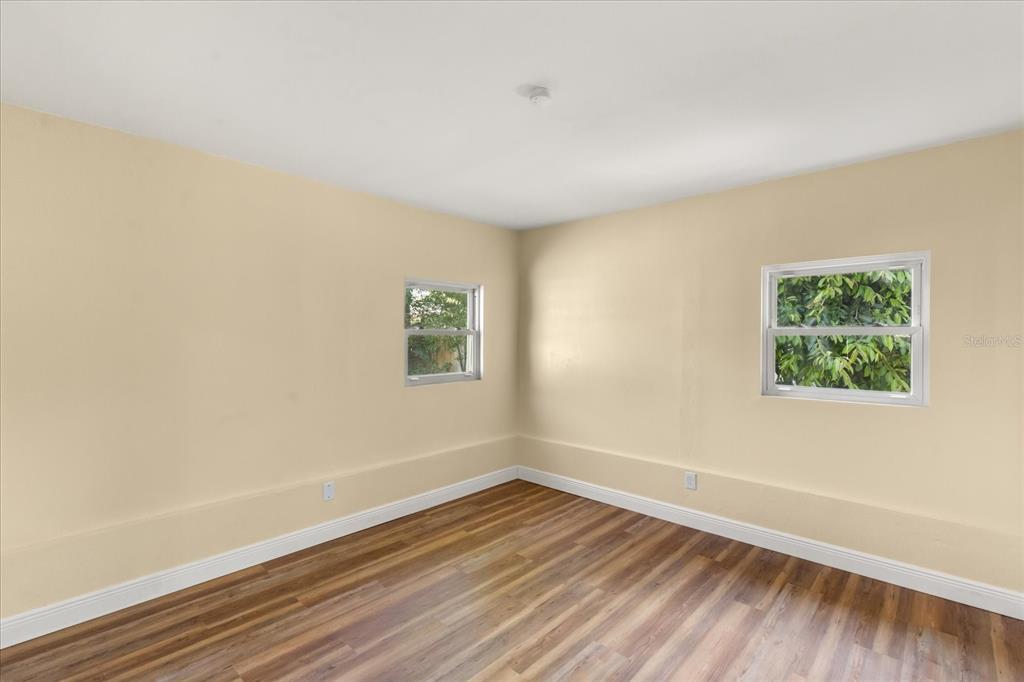 12432 136th Lane Largo, FL 33774 - Photo 17 of 24 a view of an empty room with wooden floor and a window