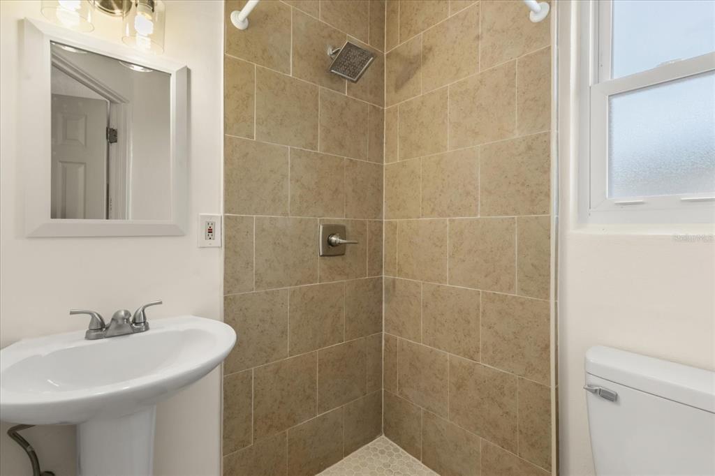 12432 136th Lane Largo, FL 33774 - Photo 19 of 24 a bathroom with a sink shower and a mirror