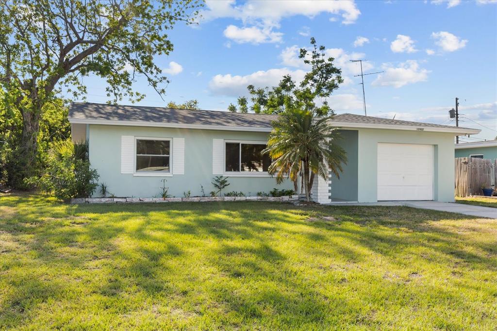 12432 136th Lane Largo, FL 33774 - Photo 2 of 24 a view of a house with swimming pool and a yard