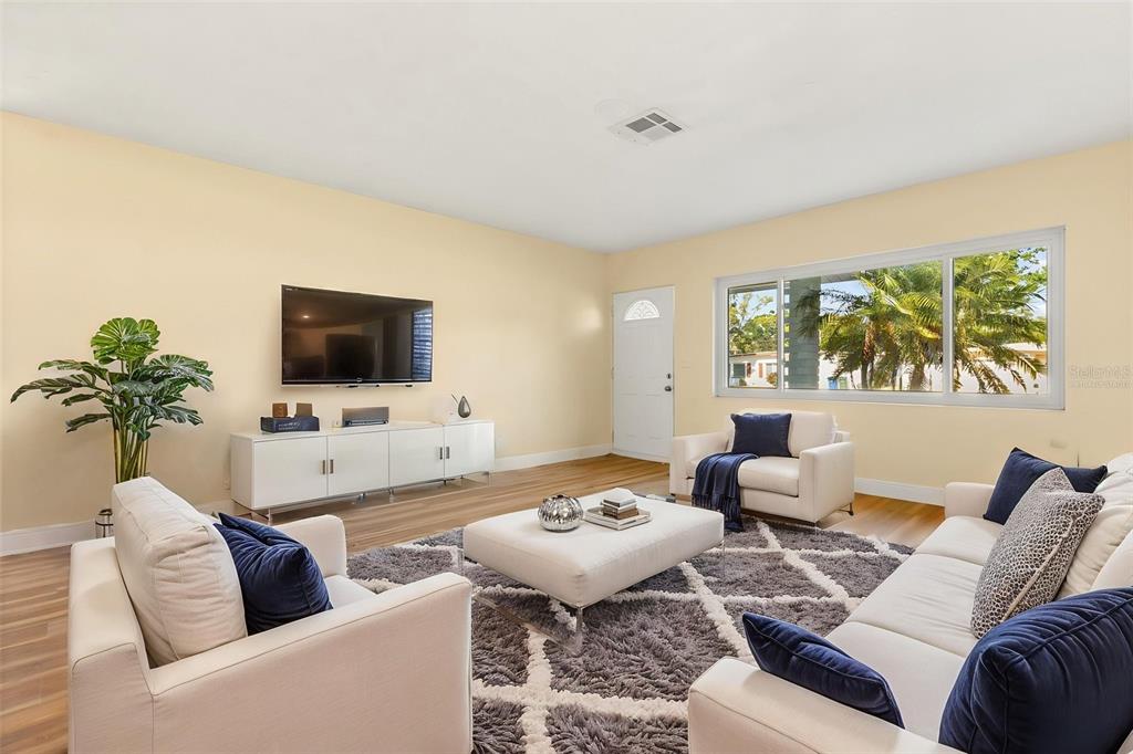12432 136th Lane Largo, FL 33774 - Photo 5 of 24 a living room with furniture and a flat screen tv