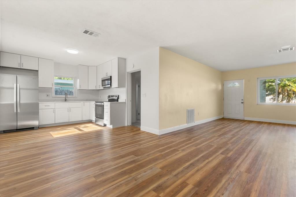 12432 136th Lane Largo, FL 33774 - Photo 7 of 24 a view of a kitchen with wooden floor and electronic appliances