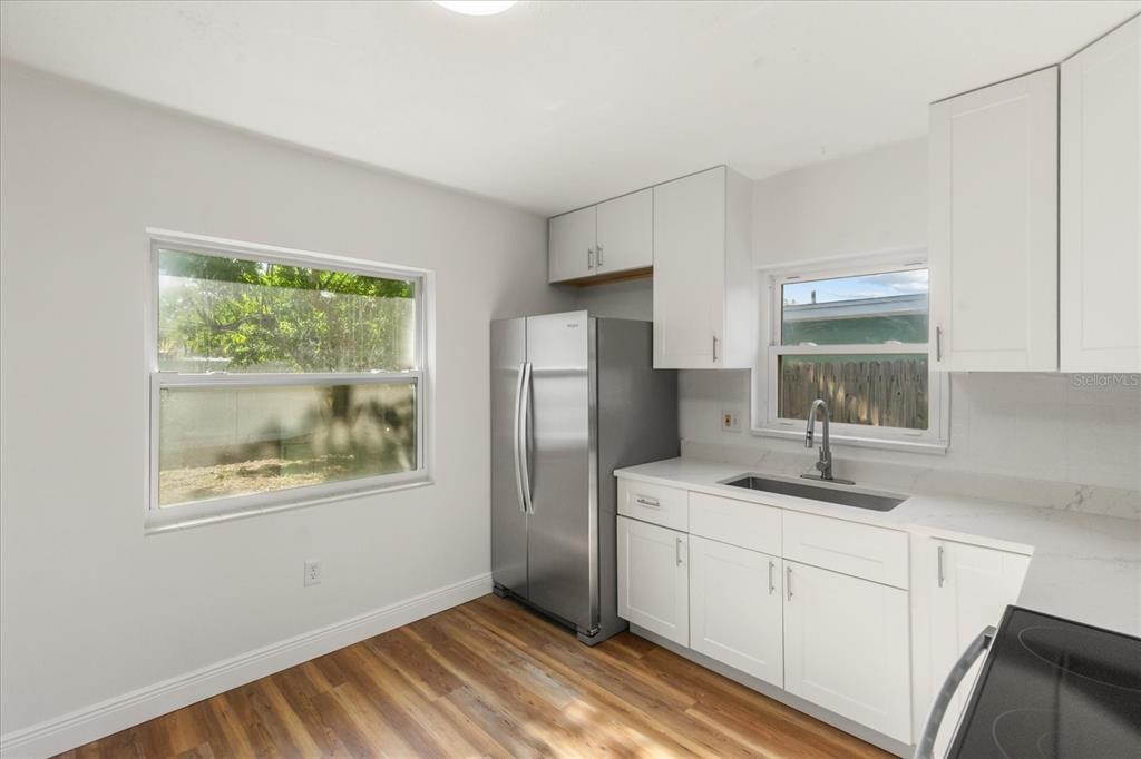 12432 136th Lane Largo, FL 33774 - Photo 8 of 24 a kitchen with stainless steel appliances granite countertop a refrigerator sink and window