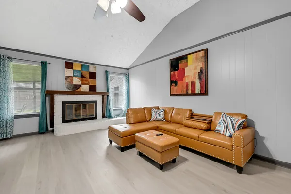 a living room with furniture and a fireplace