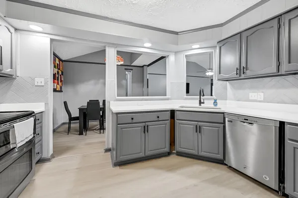 a kitchen with a sink cabinets and appliances