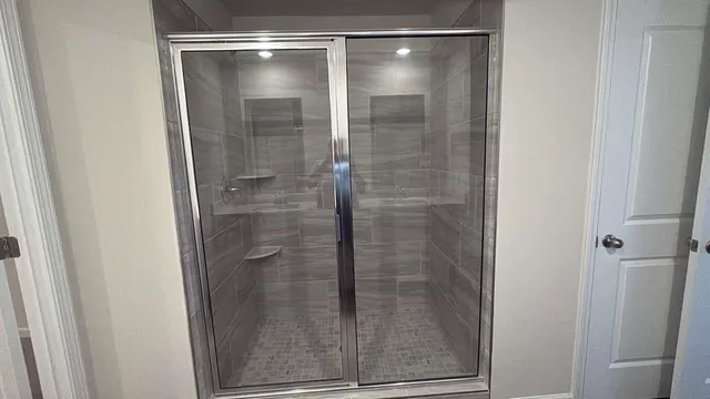 a bathroom with a glass shower door