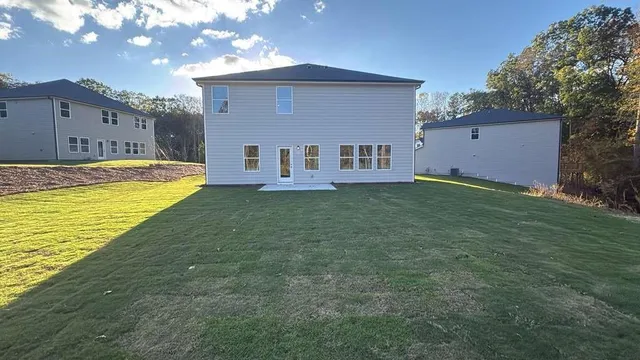 a view of a house with a backyard and a patio