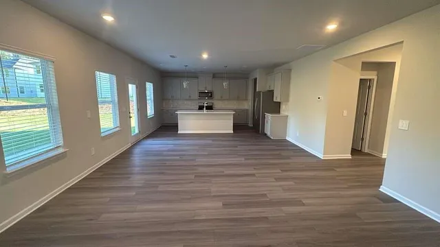 a view of a kitchen with cabinets and wooden floor
